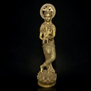 a gold statue of a mermaid holding a bird