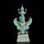 a statue of a person on a bird