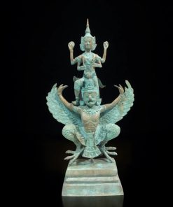 a statue of a person on a bird