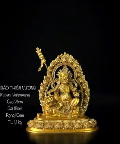 a gold statue of a man sitting on a lion