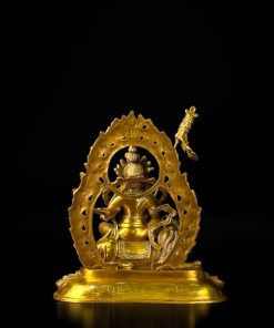 a gold statue of a man sitting on a chair