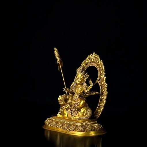 a gold statue of a person holding a spear