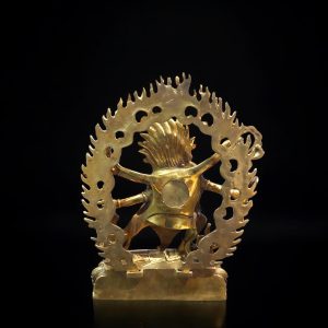 a gold statue of a person holding a tree