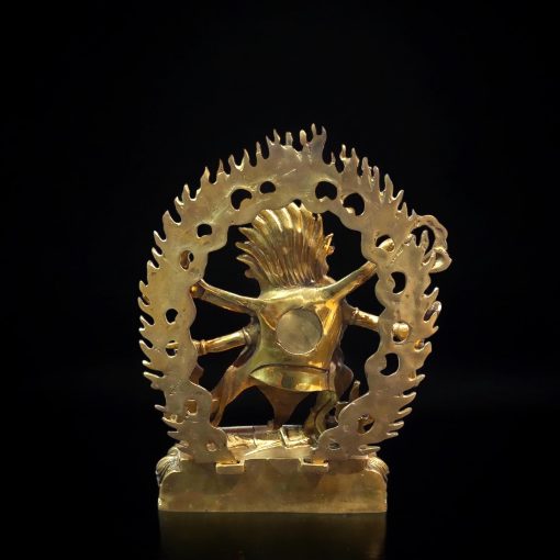 a gold statue of a person holding a tree