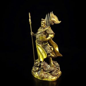 a gold statue of a man holding a sword and a spear