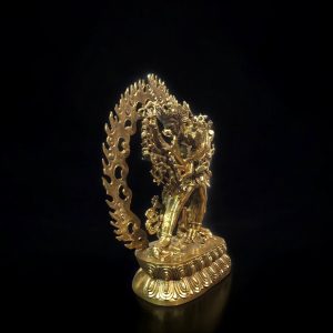 a gold statue of a person holding a dragon