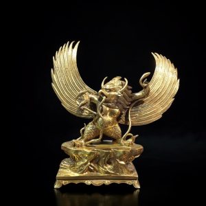 a gold statue of a mythical creature
