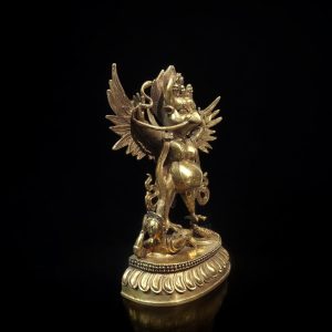a gold statue of a bird