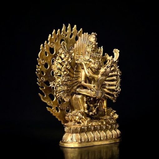 a gold statue of a person with many arms