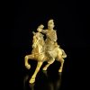 a gold statue of a man on a horse