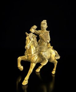 a gold statue of a man on a horse