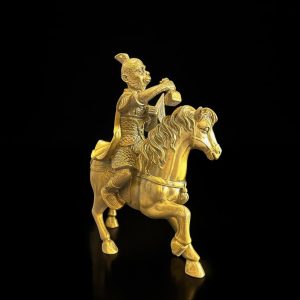 a gold statue of a man riding a horse