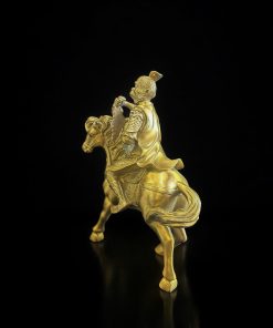 a gold statue of a man riding a horse
