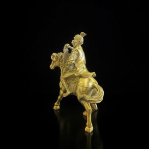 a gold statue of a man on a horse