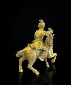 a gold statue of a man riding a horse